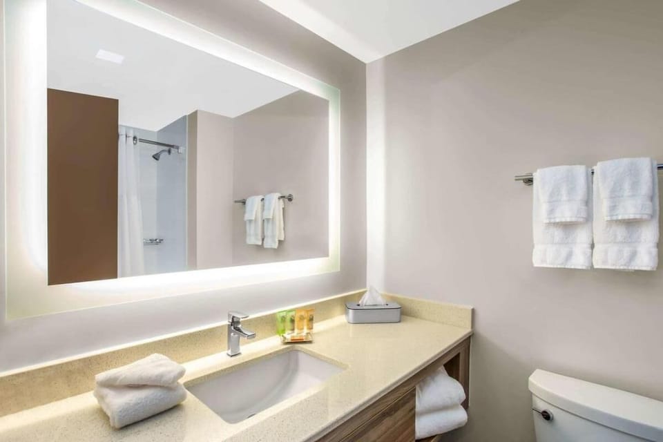 Refresh each morning at a glowing mirror and spacious vanity.