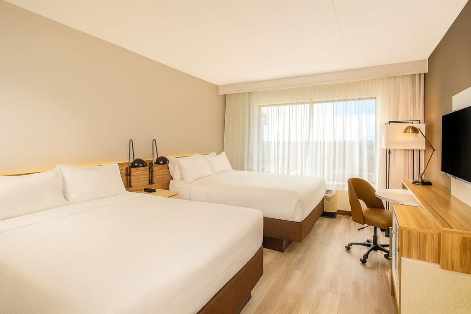 Settle into bright comfort with two plush beds and space.
