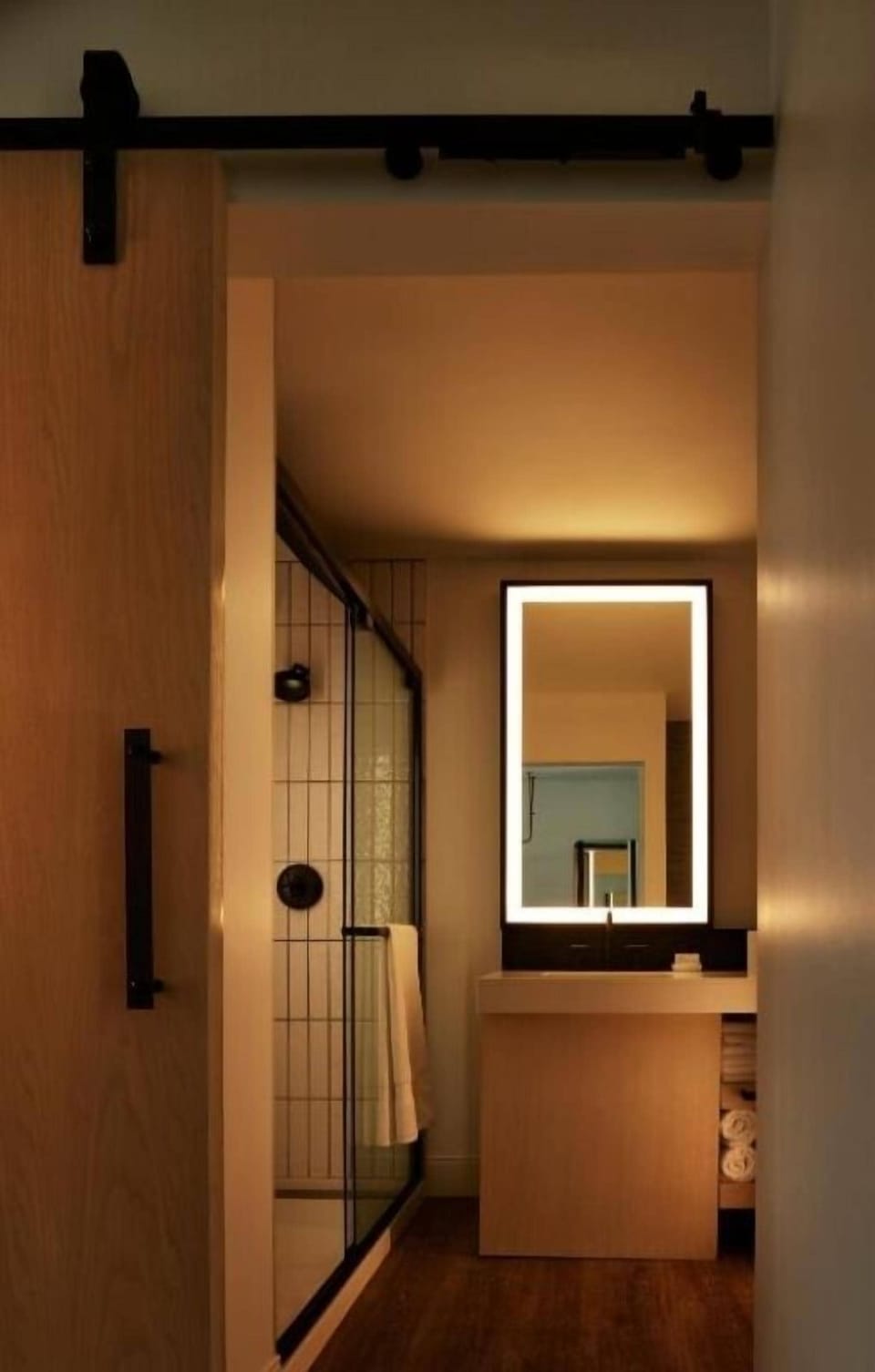 Refresh in a sleek shower with warm, calming lighting.