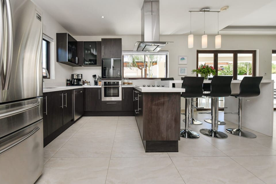 Fully-equipped modern kitchen with fridge, stove, oven, microwave, dishwasher