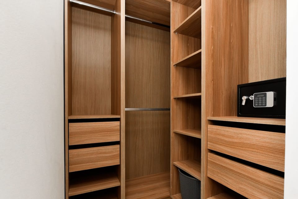 Master bedroom walk-in closet with safe