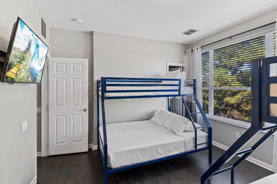 Fun-Filled Slumber Parties Await: Bedroom 3 Features Two Single over Double Bunk Beds for Ultimate Sleepovers.