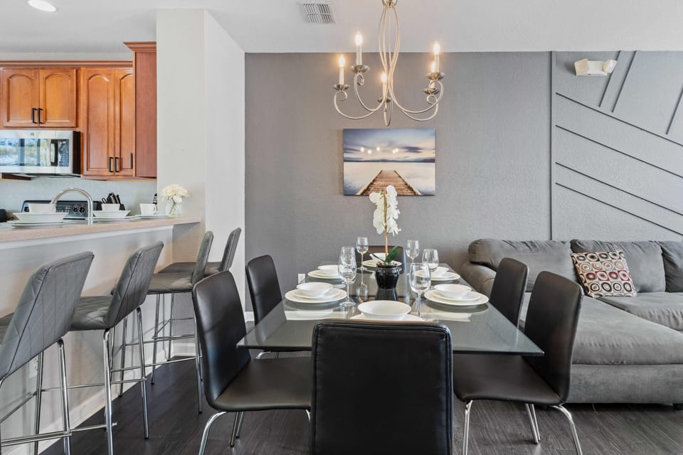 Sleek and Social: Experience the allure of our living area, harmoniously combining a contemporary kitchen and a social dining space for an urban retreat