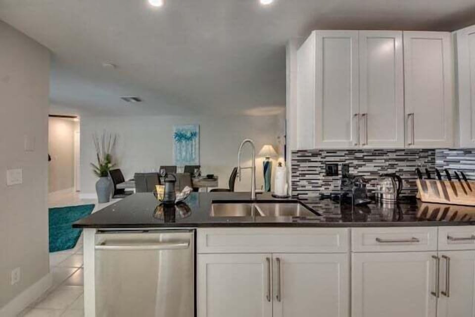 new kitchen is fully equipped with modern appliances and has a high-quality black granite worktop