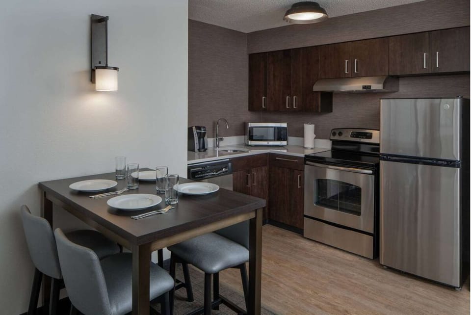 Gather for easy meals in this sleek, stocked kitchen.