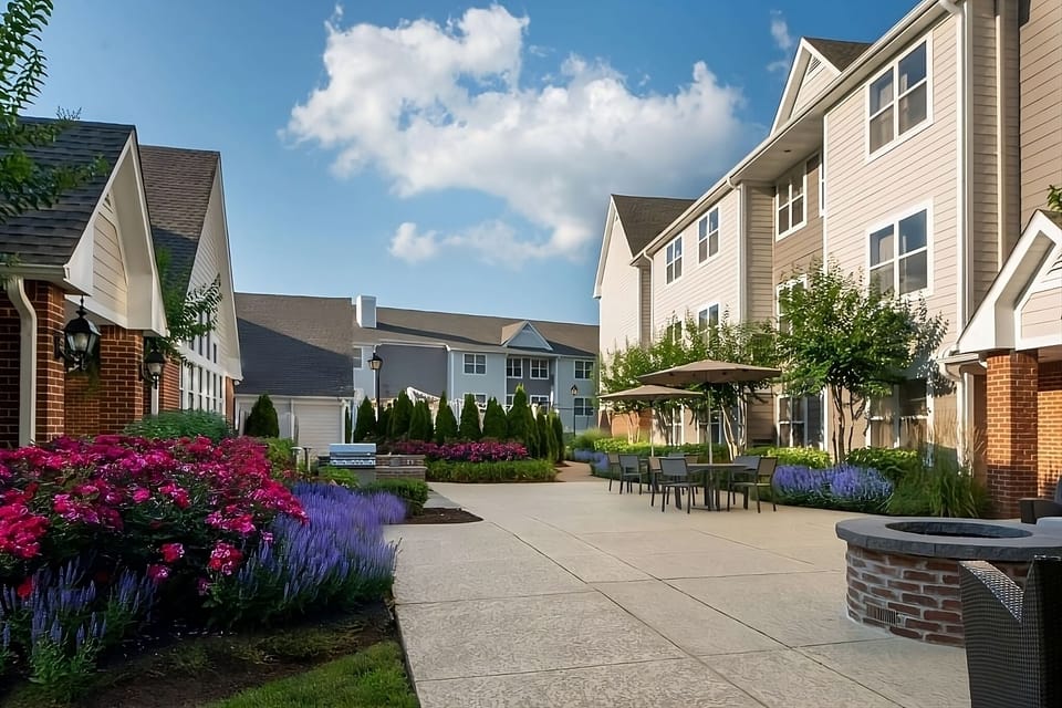 Sip coffee outside surrounded by colorful gardens and open skies.