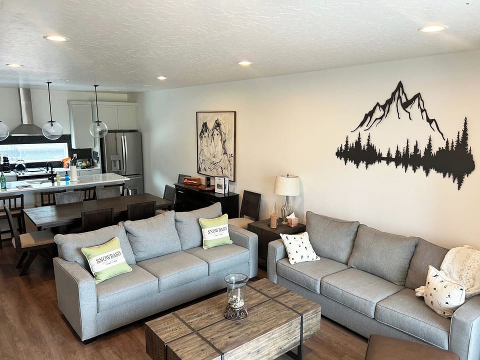 The open-concept living space, complete with a dining area, facilitates effortless conversation with family and friends.