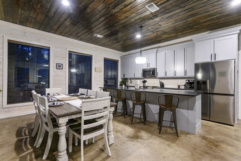 Dining area with a table that seats 8 and additional barstools