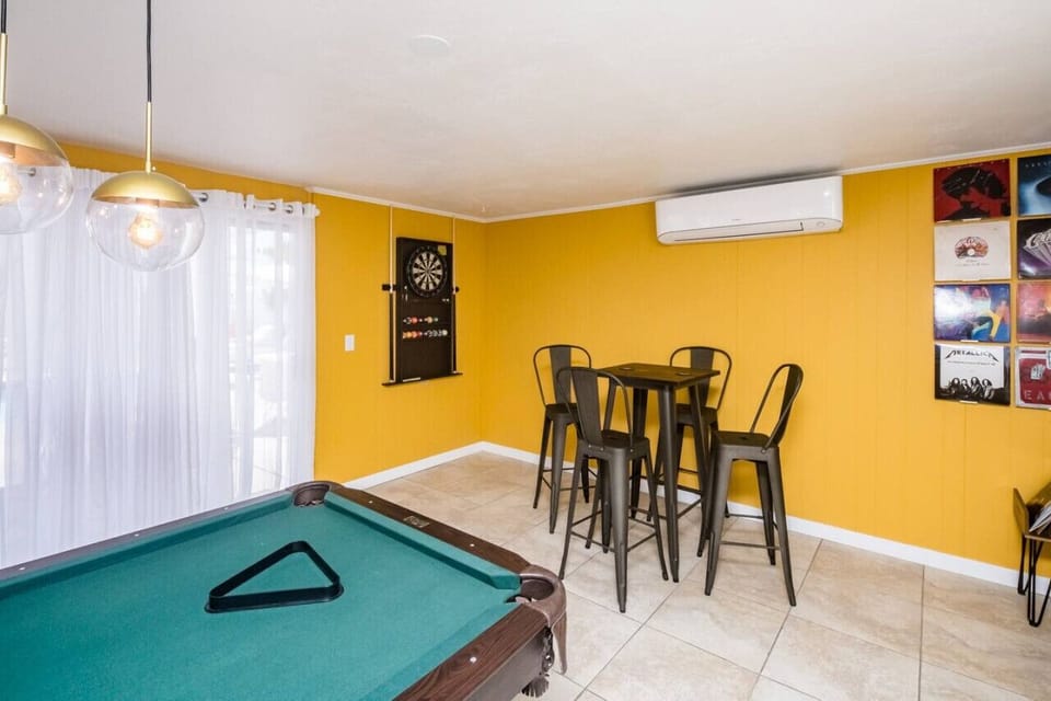 Entertainment area with pool table and dart board.