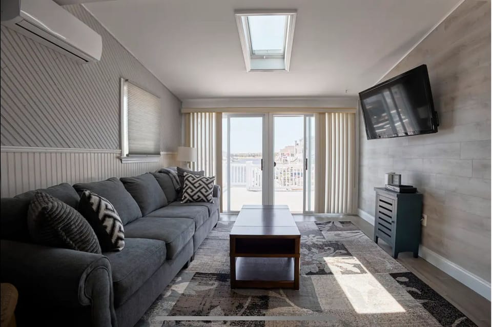 Living room with cable television and access to rear deck
