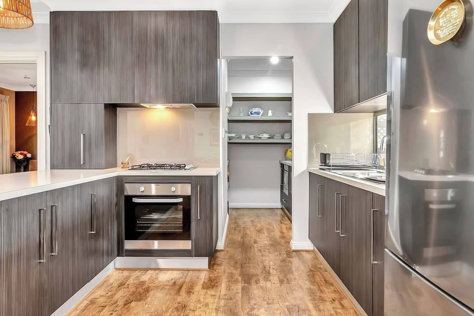 Designed around a central breakfast bar, the kitchen is a sleek space to prepare meals using the region’s fresh local produce.
