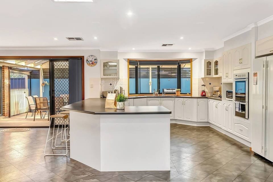 A fully-equipped kitchen has high-end appliances including an oven gas cooktop, full-sized fridge, microwave, blender, coffee maker and more
