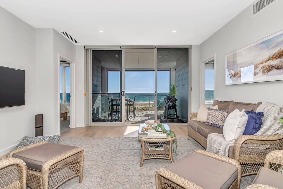 The living area flows directly to the balcony, creating a seamless transition to the outdoors.
