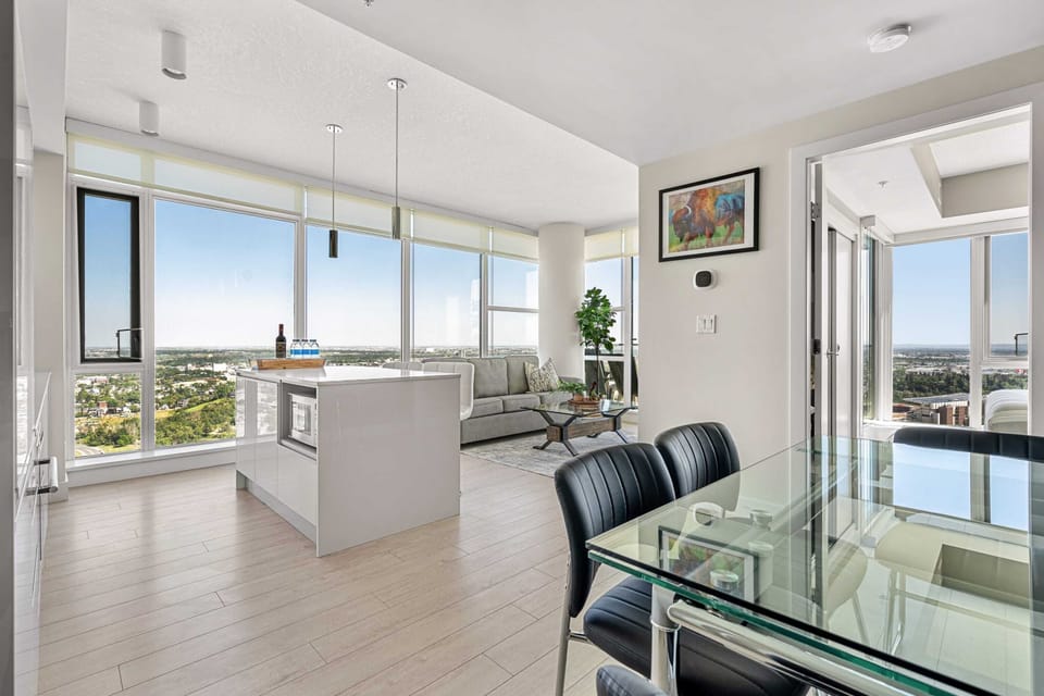 Floor-to-ceiling windows provide a bright and open main living space! The dining table seats 4, and the kitchen island seats 2!