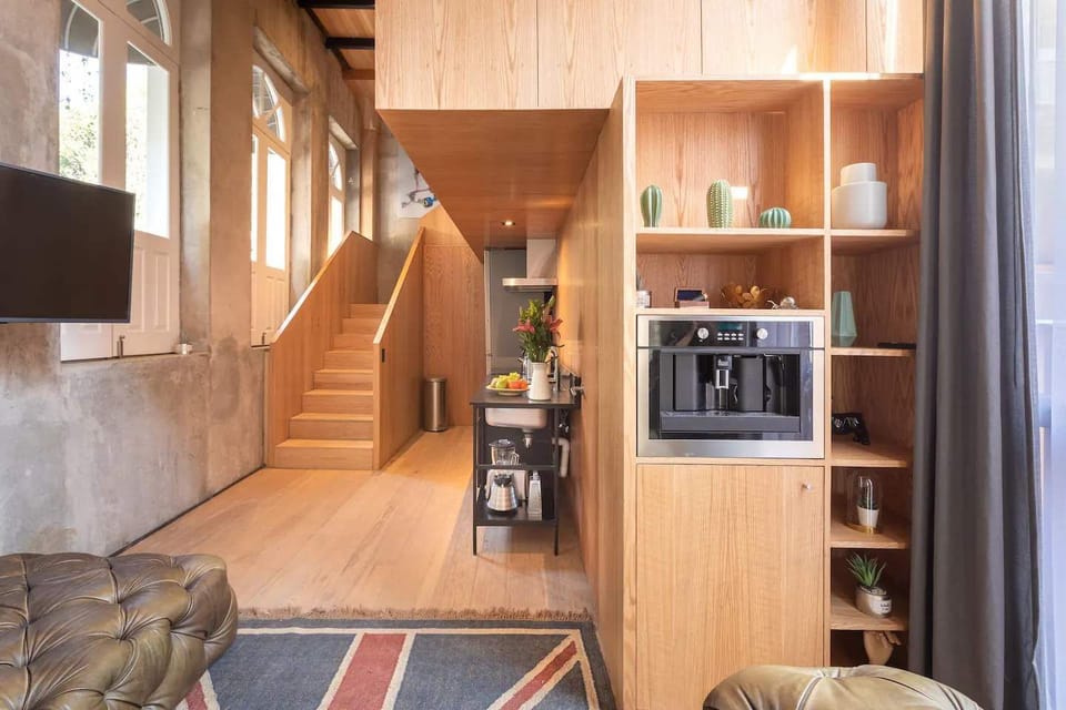 Modern kitchen with a coffee machine and sleek shelving.