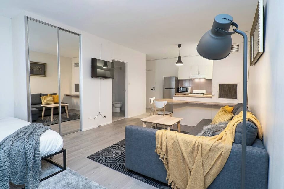 The open plan living space features a comfortable sofa and Netflix-ready TV to enjoy a cosy night at home. 