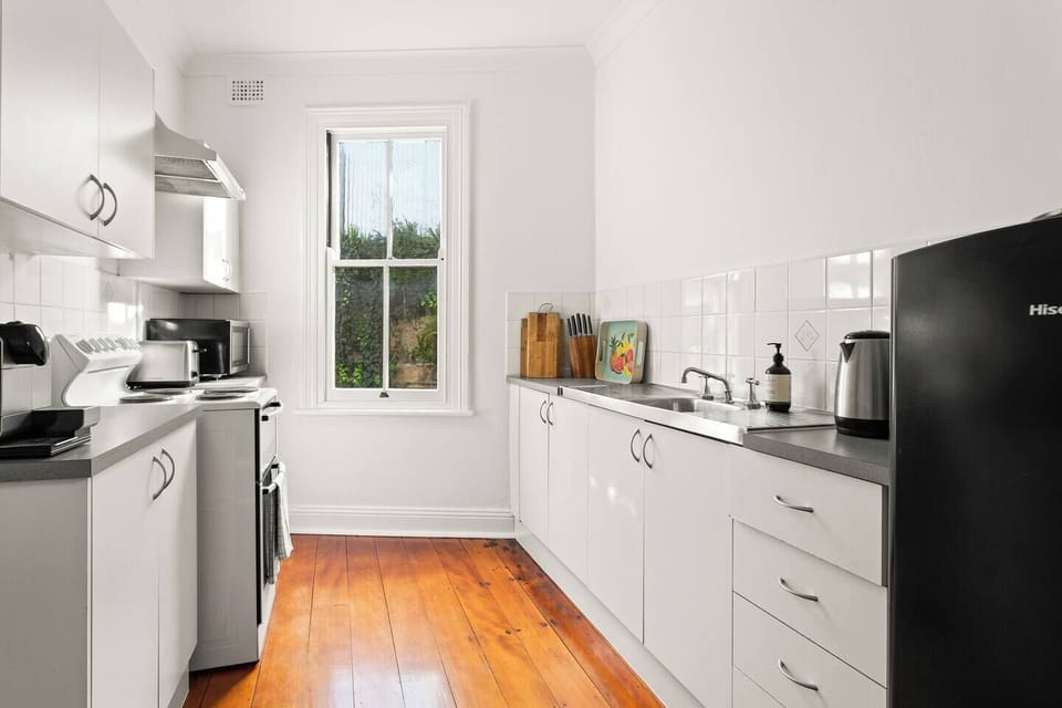 A kitchen has premium appliances such as a brand new electric stove and oven with separate grill, Breville microwave and Nespresso coffee machine