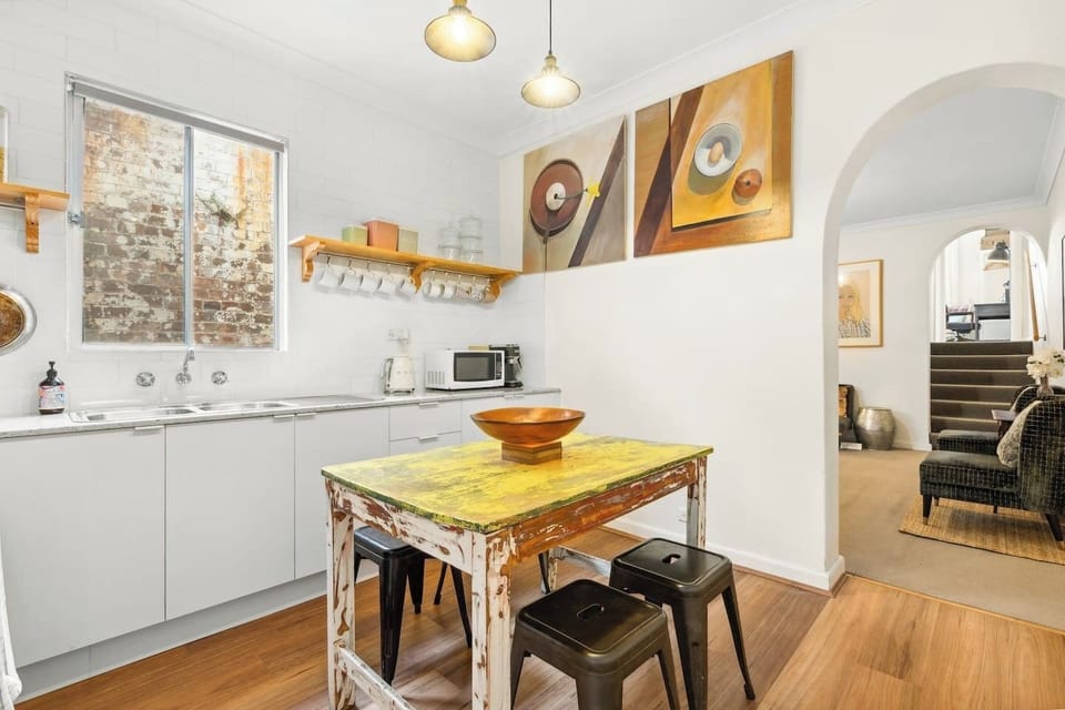The kitchen is beautifully presented where you'd feel right at home, with a central dining table for four. 