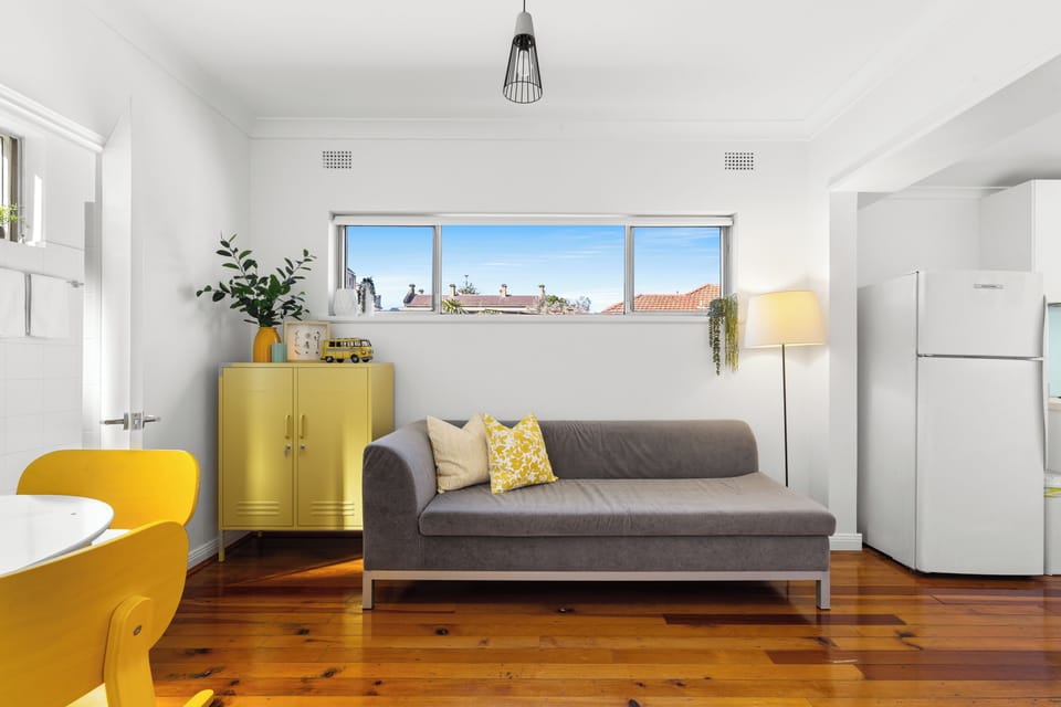 Enjoy the living area’s bright, personality-filled styling, where warm timber floors and colourful details give this cosy corner an uplifting feel.