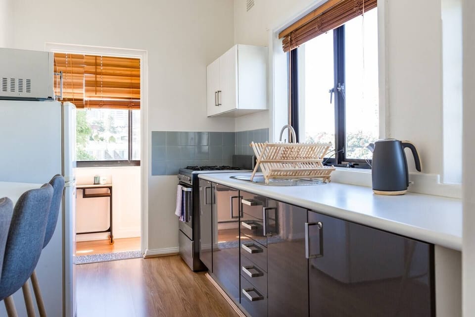 Kitchen links to the sunroom that has a study table.