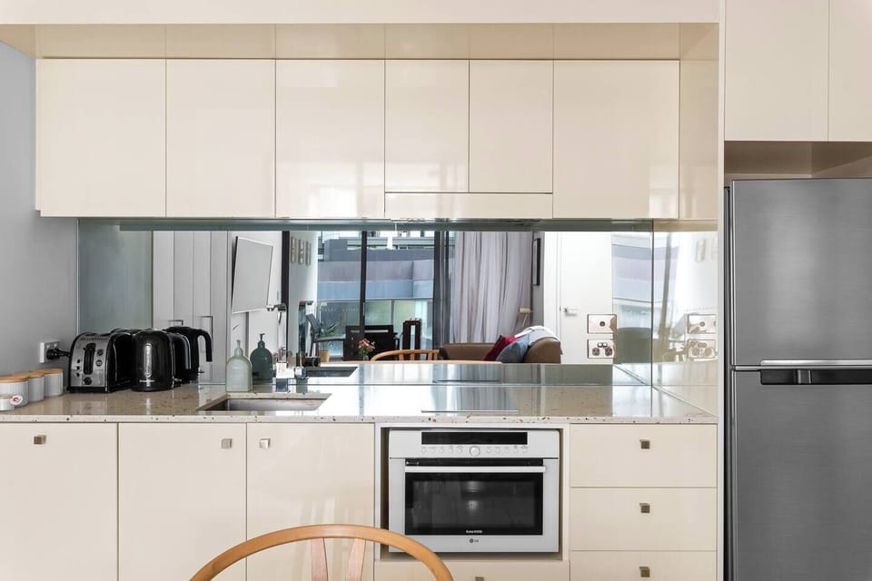 The compact kitchen is equipped with the appliances and utensils you'll need to cook a meal at home.