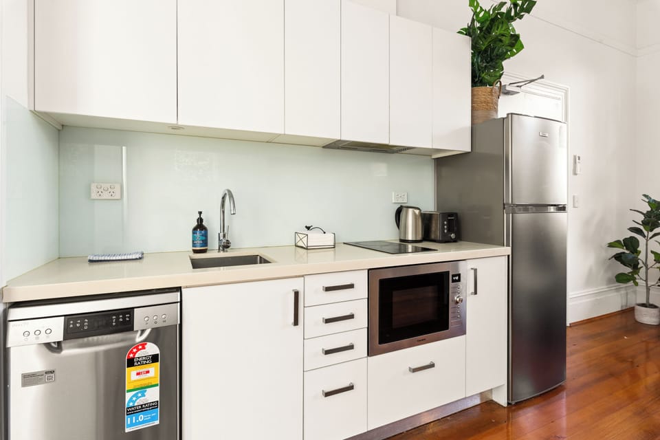 Enjoy meals at home with a modern kitchen featuring an electric cooktop, combi oven/microwave, fridge and dishwasher, and all the cooking tools you'll need.