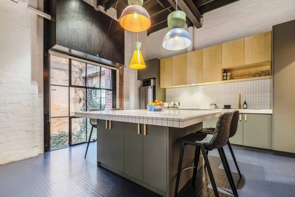 The kitchen centres around a tiled island, offering ample space to dine or chat with the cook while they whip up meals.