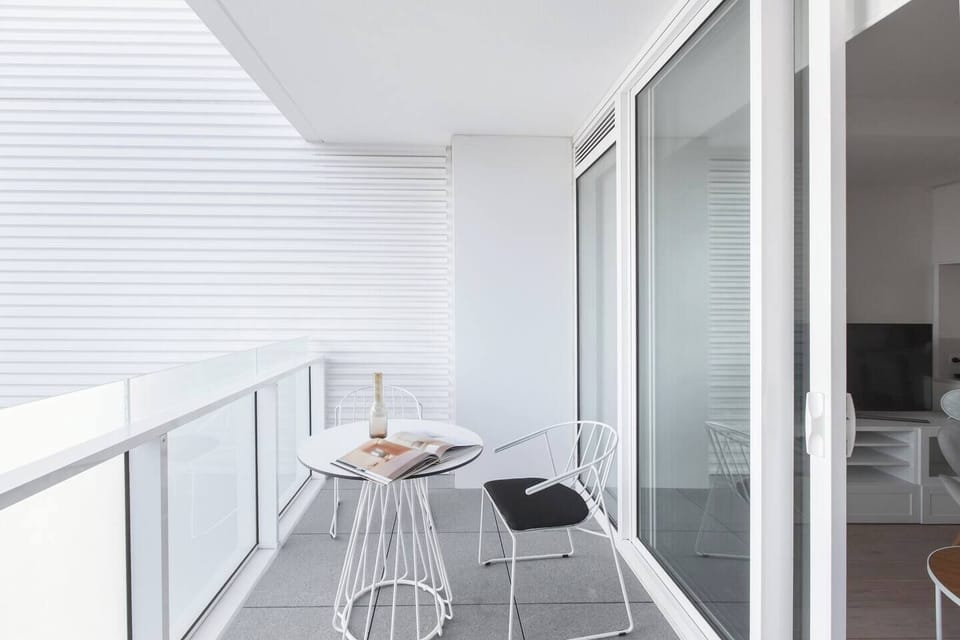 Enjoy a glass of wine before bed or a cup of coffee in the morning on the private balcony off the living room of the apartment