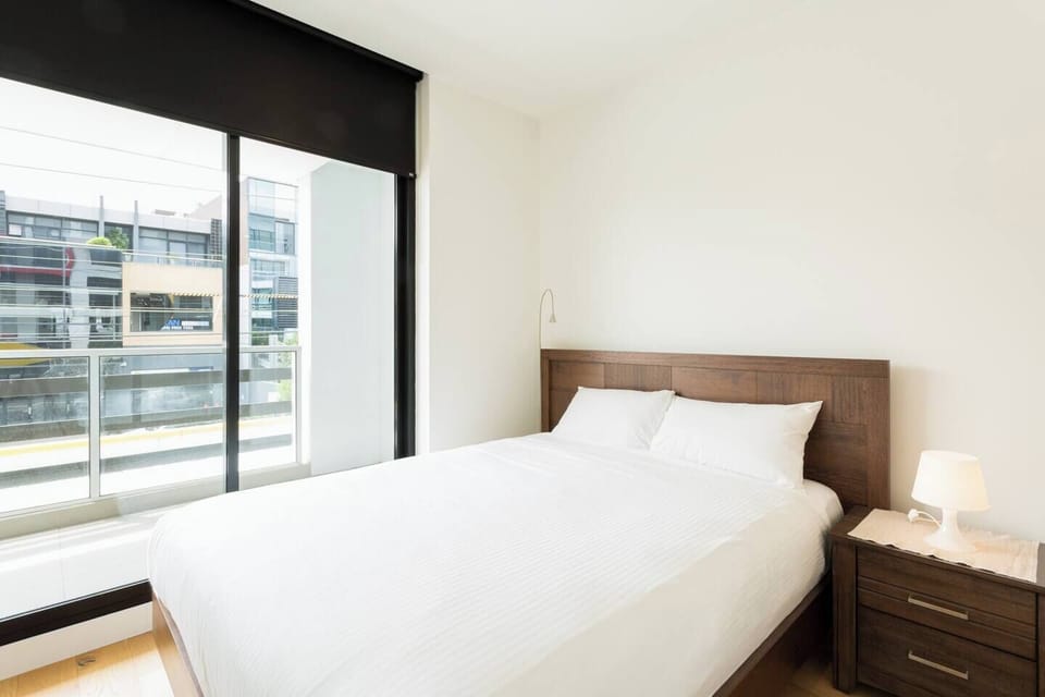 The second bedroom offers a plush queen bed with hotel quality linen, plenty of storage and access to the private balcony