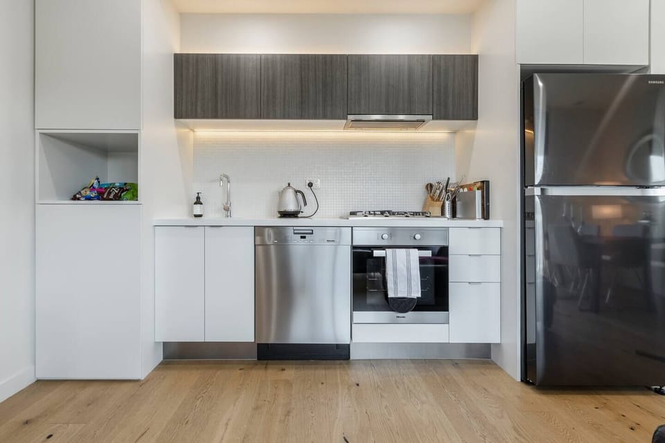A gourmet kitchen comes equipped with Miele appliances, including a dishwasher for easy clean-up.
