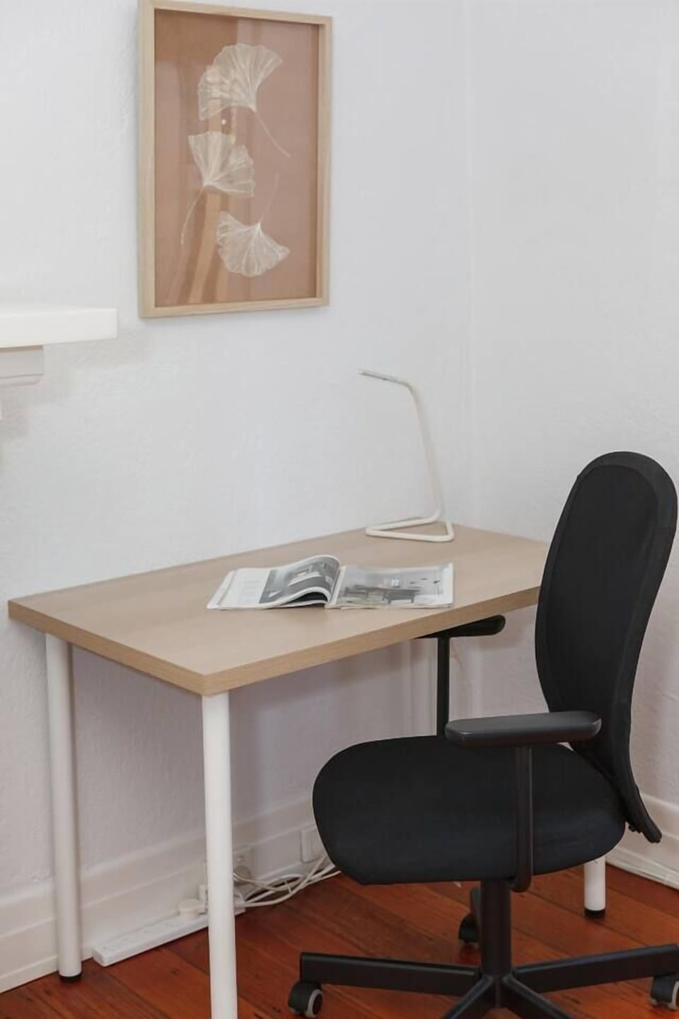 A dedicated workspace within the primary bedroom caters to those on a business trip or needing to set up their laptop with a proper desk and chair.