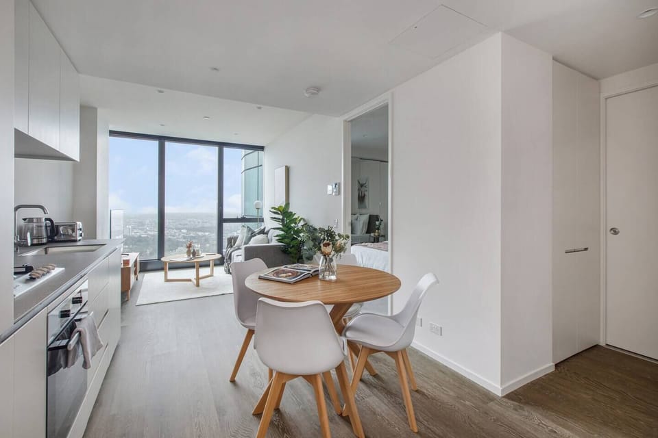 A welcoming, open-plan layout includes a four-seater table setting to enjoy meals at home. 
