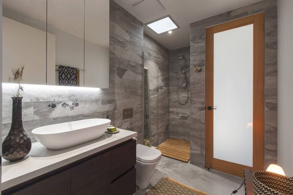 A stylishly presented bathroom includes a spacious shower, toilet and mirrored vanity stocked with boutique amenities for use during your stay.