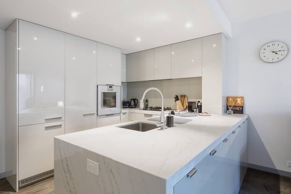 The state-of-the-art kitchen features bespoke cabinetry and come fully equipped to cook meals at home.