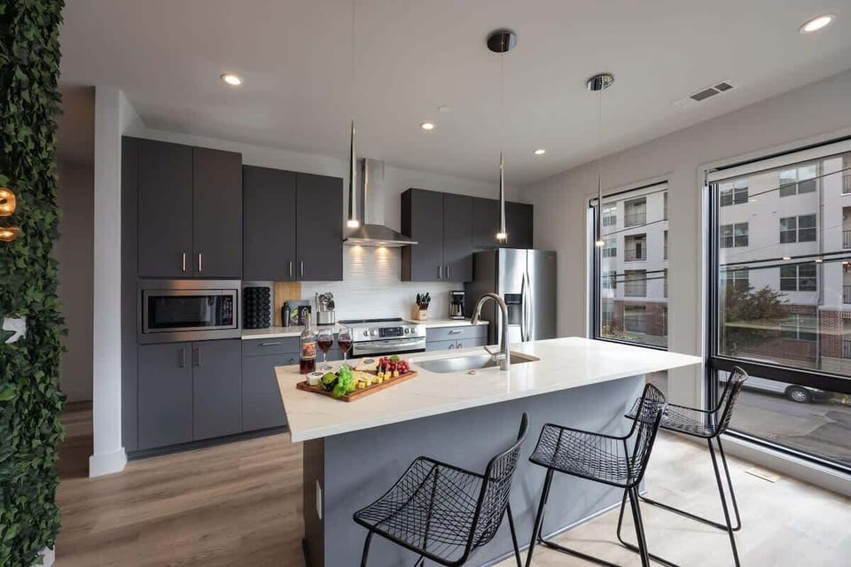 Fully equipped kitchen stocked with your basic cooking essentials, stainless steel appliances, and breakfast bar seating.