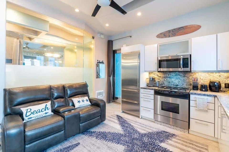 Modern kitchen with full-size stainless steel appliances.