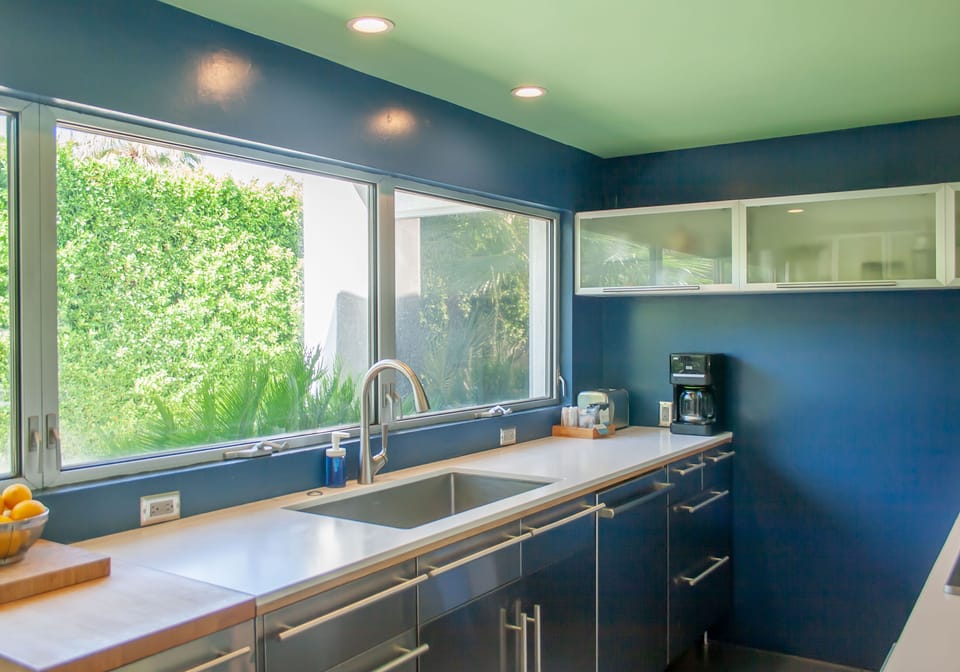 Bright kitchen with garden views, stainless appliances, and ample counter space