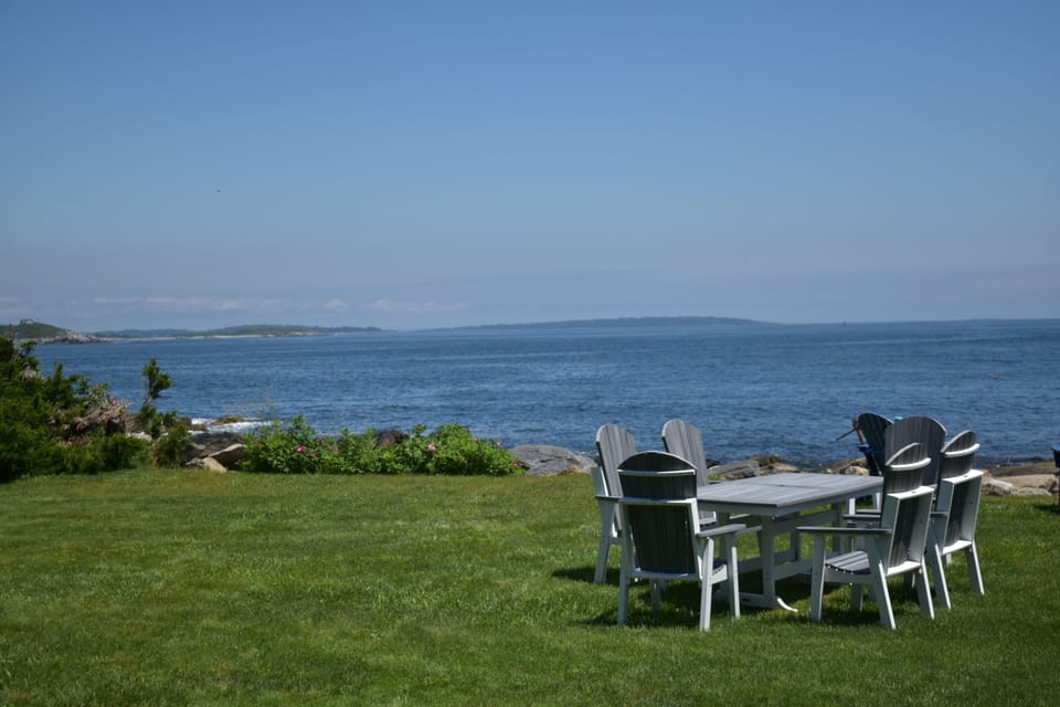 The yard with picnic and seating area overlooking the ocean
