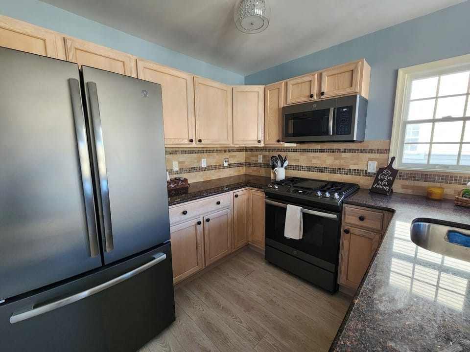 Well appointed kitchen with stainless steel appliances. 