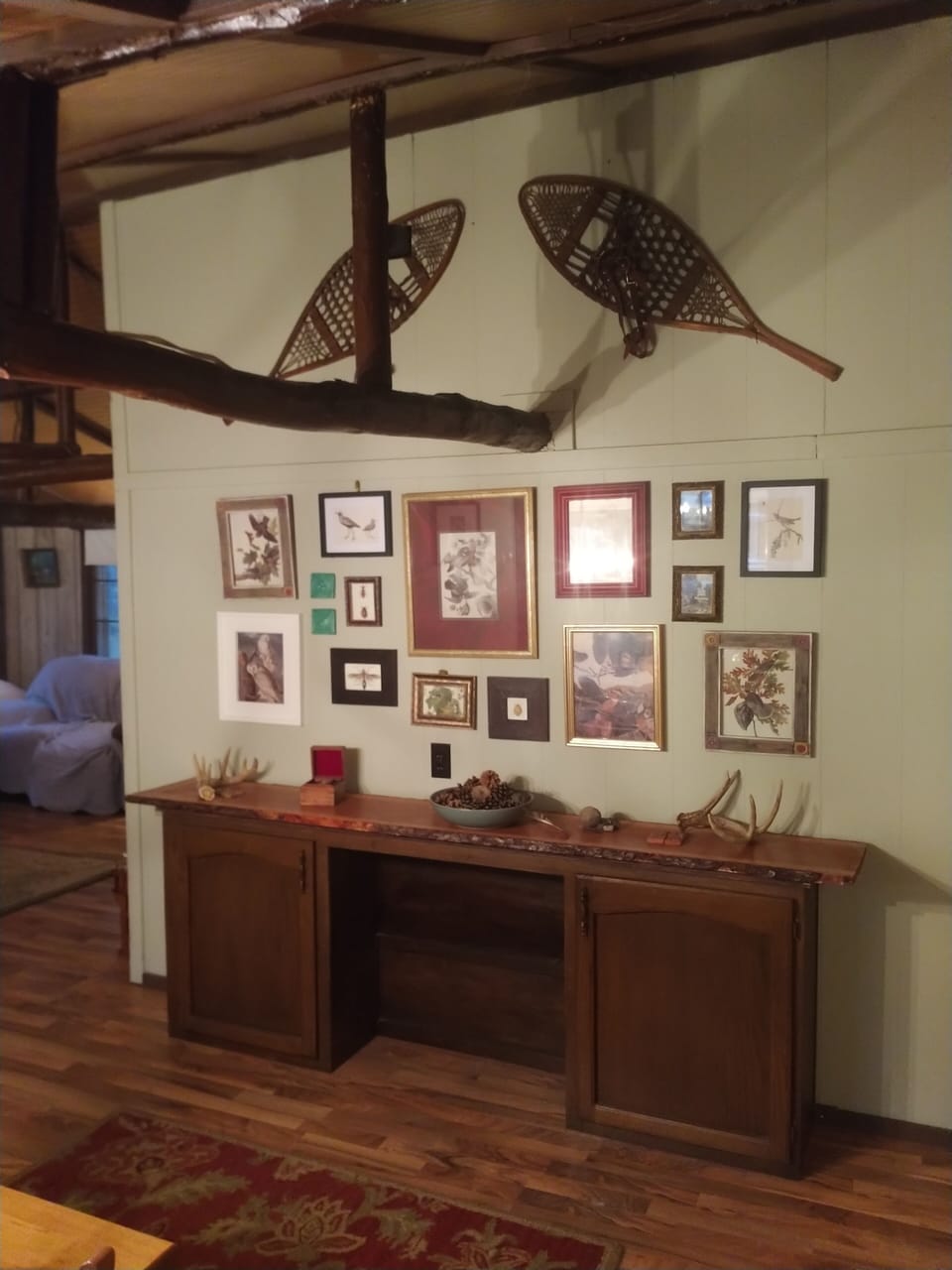 dining area wall with log beamed ceiling.