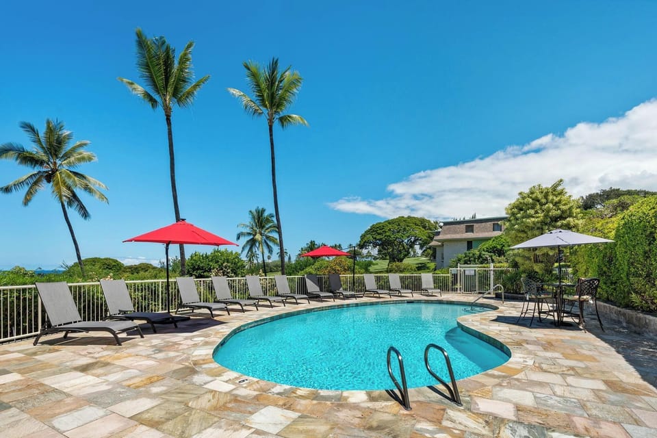 Dive into crystal-clear waters surrounded by swaying palms and tropical paradise, where your perfect poolside retreat awaits.