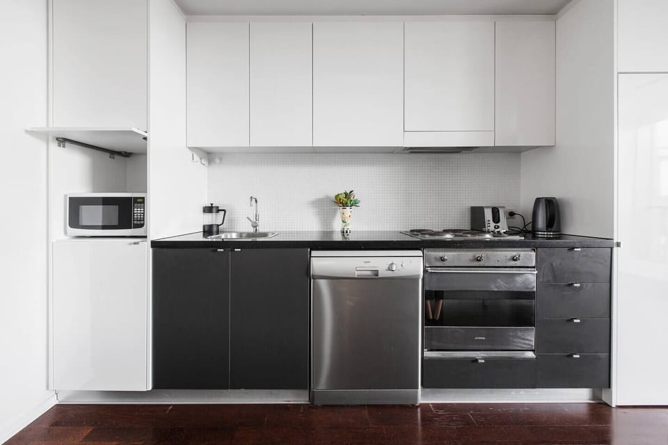 The sleek kitchen is well-equipped to prepare meals at home.