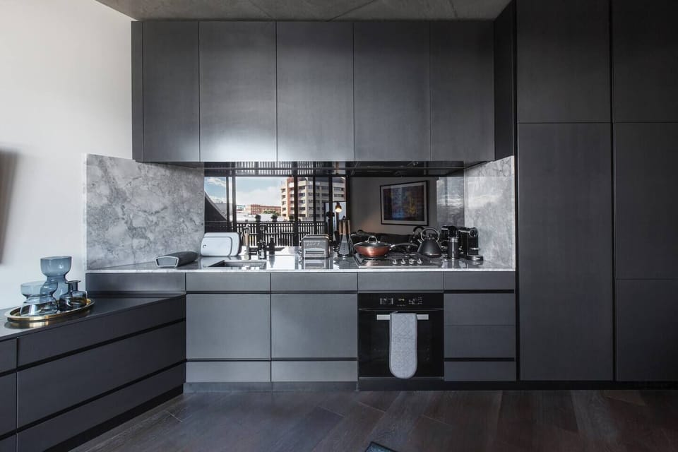 A contemporary, fully-equipped kitchen has a gas stove, oven, full-sized fridge, microwave, dishwasher and coffee maker, as well as all the necessary cooking utensils