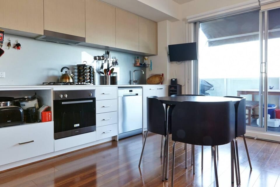 The kitchen is fully equipped and has a dining table set for four. The TV on the wall extends out and can be angled depending on where you are watching it from. 
