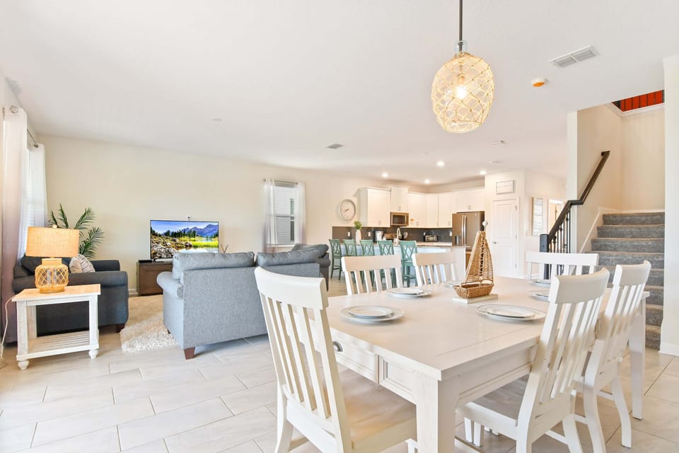 Elegant open-concept dining and living area with coastal charm and modern touches
