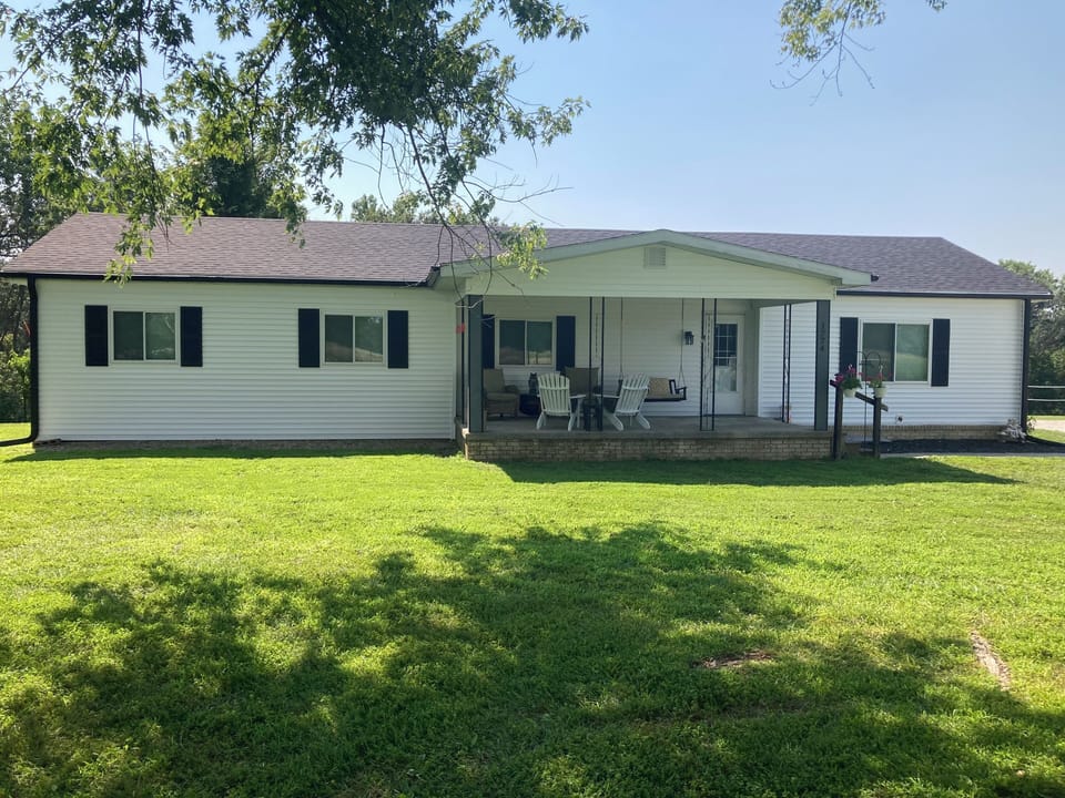 Completely remodeled country home with covered front porch with seating for 6+