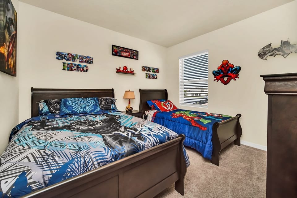 Exciting superhero-themed bedroom perfect for kids, featuring vibrant decor and cozy beds.