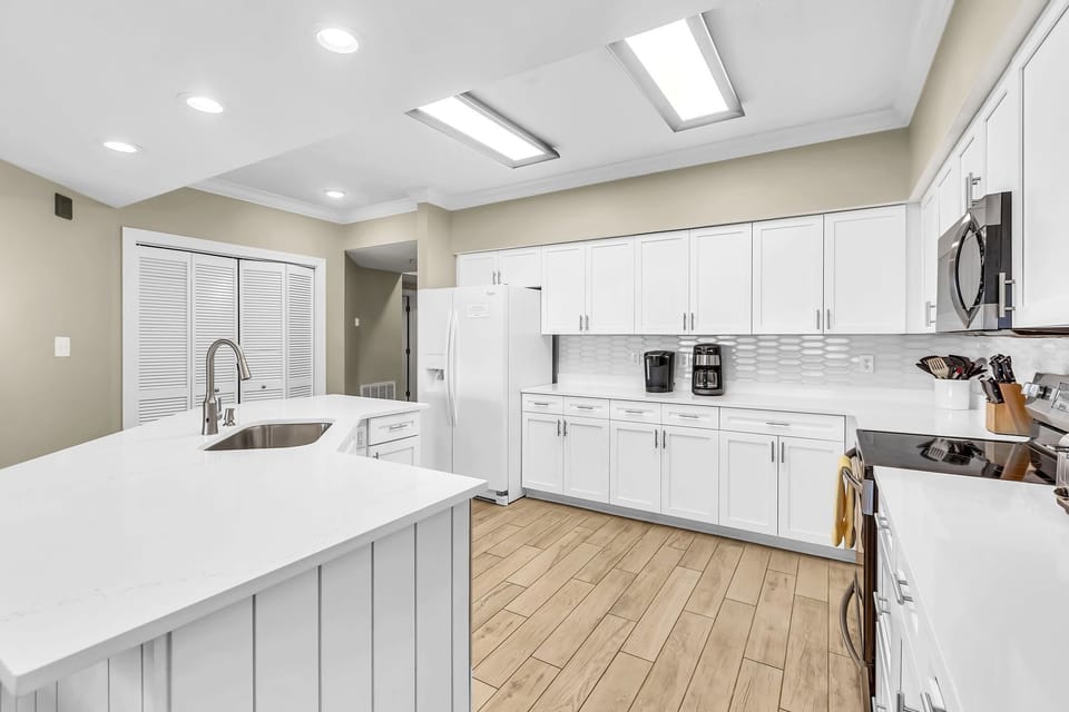 Effortless flow and abundant natural light characterize this stunning condo. The kitchen's thoughtful design and open layout create an inviting atmosphere for both cooking and gathering.