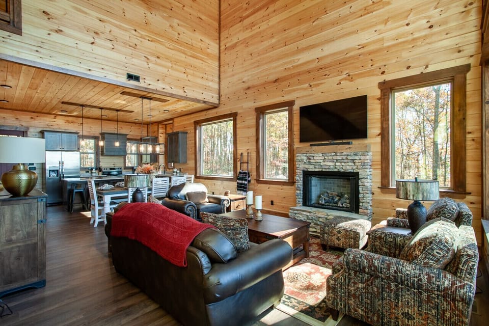 With a stone fireplace, comfy seating, and a bright open layout, this space is perfect for relaxing and entertaining.