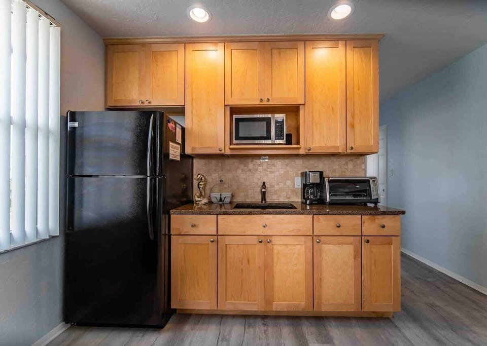 Remodeled 2021.
Kitchenette w/ fridge, freezer, ice maker, microwave, coffee maker, toaster oven, 2 stove plug in burner, blender, plates, silverware, glasses, Bluetooth speaker and mini cooler for the beach/pool.